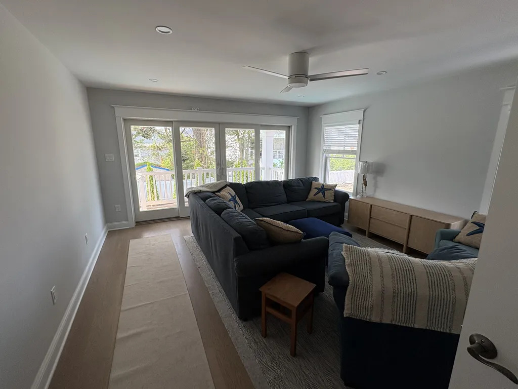 Den with wet bar leading to pool