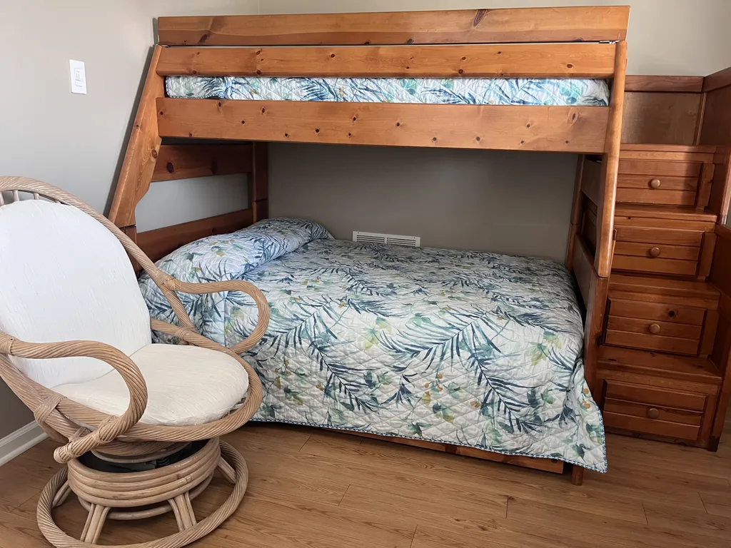 View of bunk in third bedroom, step drawers hold sheets