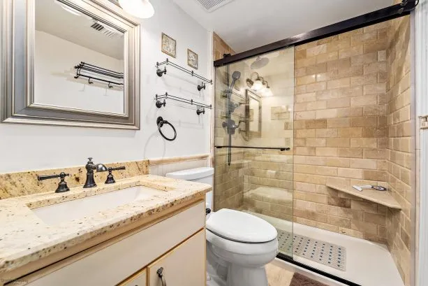 Tiled Bathroom w/Moen Polished Brass Fixtures