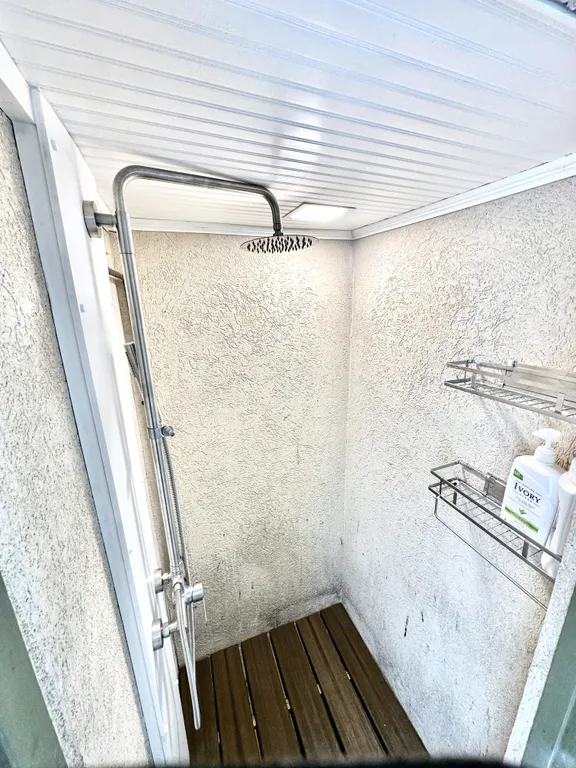 Outdoor shower with rain shower head, light, and locking door