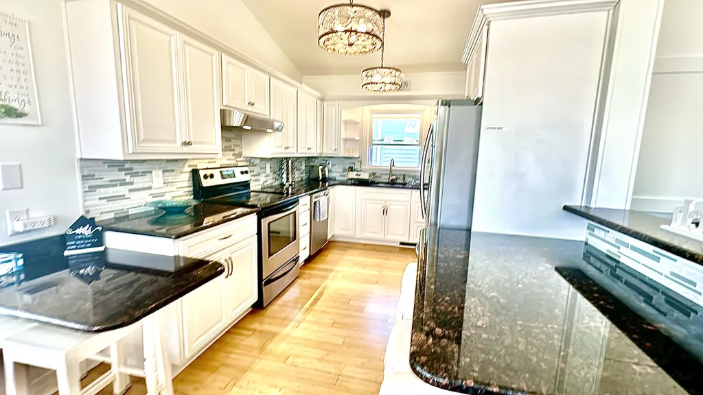 kitchen with counter seating overlooking living room