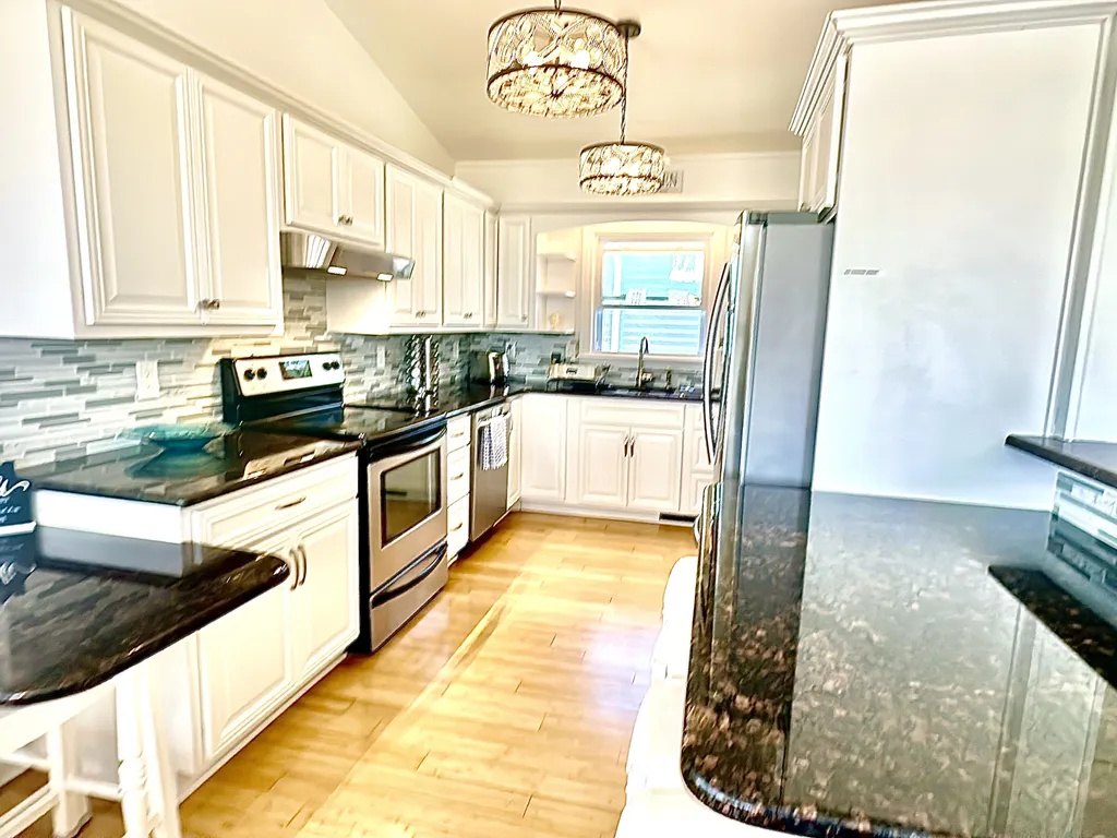 kitchen with counter seating overlooking living room
