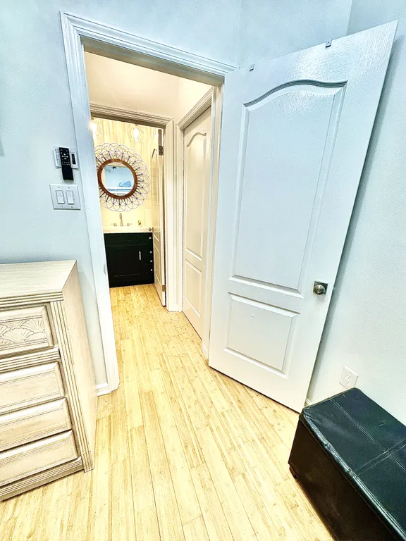 Hallway with closing pocket door between 4th bedroom and 1/2 bath