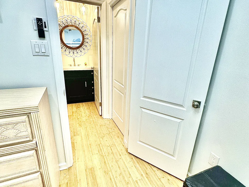 Hallway with closing pocket door between 4th bedroom and 1/2 bath