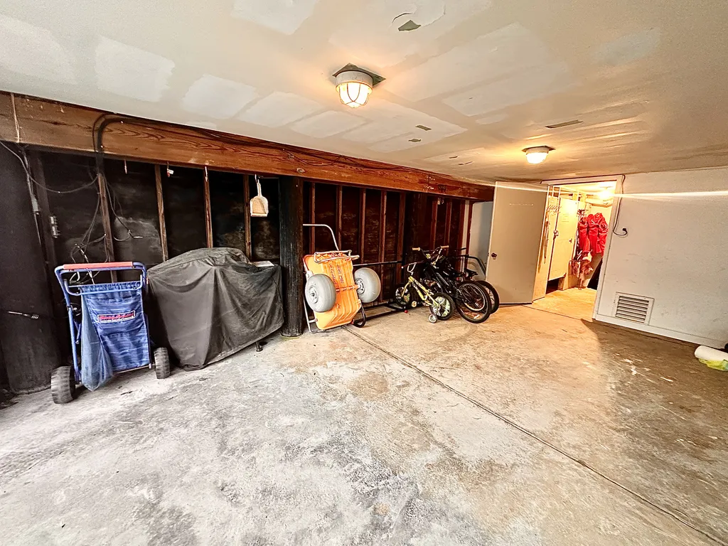 Carport with beach carts, and bike rack, and parking
