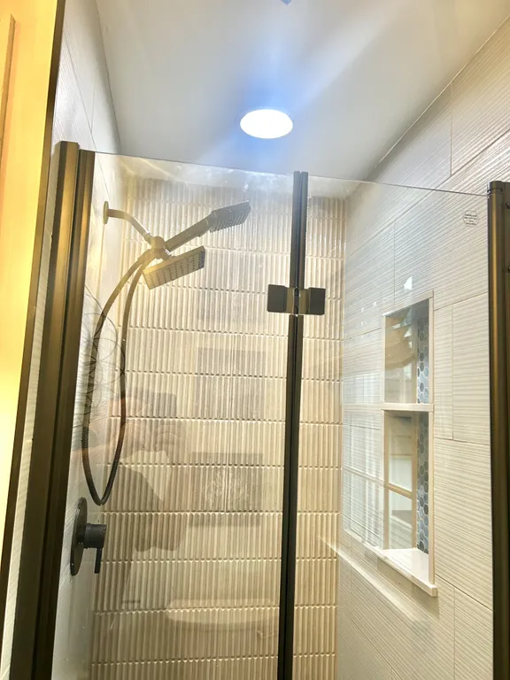 BRAND NEW Shower for 3rd full bath on 2nd floor. Pocket door can be closed to make it an en-suite for 2nd floor full bunk room or left open to give access to hall.
