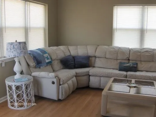 Living room has sectional with 3 recliners.