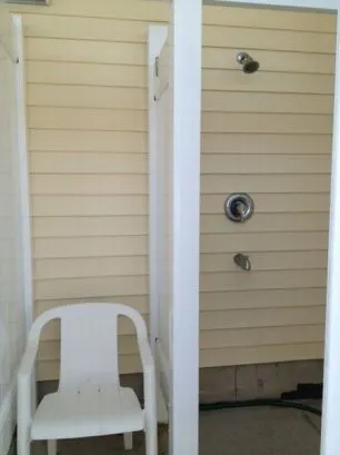 Private outdoor shower with changing area.