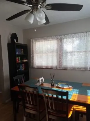 dining room with ceiling fan; window a/c